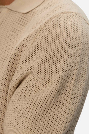 Close-up of a textured sleeve from the Industrie The Serrano Polo, highlighting the intricate zigzag pattern and detailed stitching.