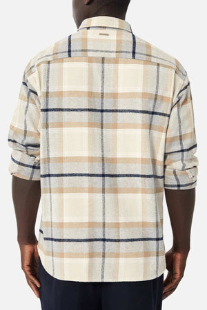 A person is seen from the back wearing Industrie The Somerville Shirt in a beige and brown plaid, featuring rolled-up long sleeves and classic branding. This relaxed-fit shirt pairs with dark pants against a plain white background.