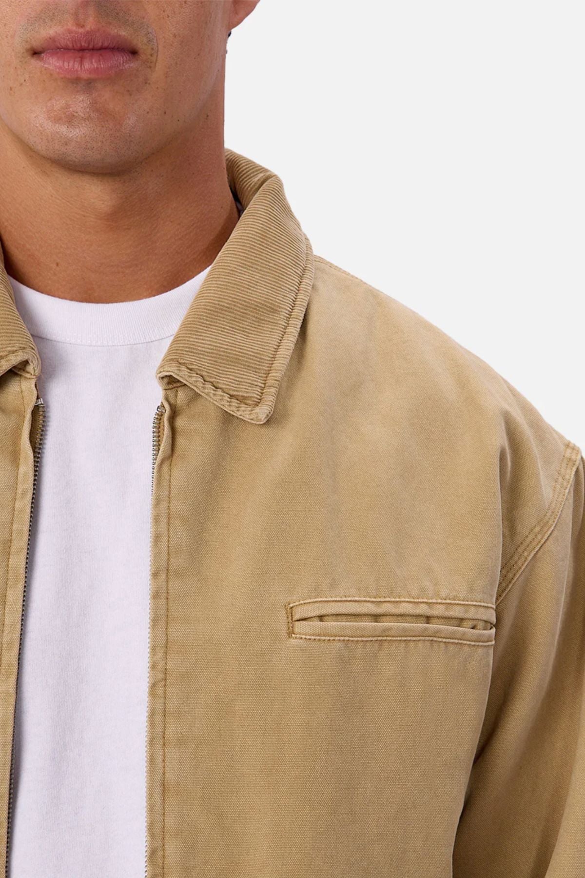 A close-up of a person wearing the Industrie The Tennesse Jacket over a white t-shirt, showing only the lower face, neck, and upper chest against a plain background.