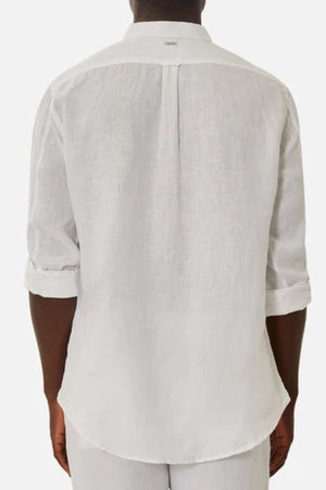 A person wears the Industrie The Tennyson Linen Blend Shirt, shown from the back. This lightweight, long-sleeve white shirt features a relaxed fit, rolled-up sleeves, and a back yoke with a central pleat.