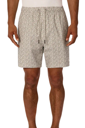 A person models Industrie The Montego Swim Short, featuring a light color, subtle geometric pattern, and drawstring waist. Only the lower torso and legs are shown against a plain background.
