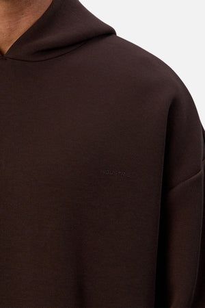 Close-up of a person wearing the Industrie The Tech Del Sur Hoodie, featuring breathable athletic fabric and discreet “INDUSTRIES” embroidery on the chest. The focus is on the upper torso and shoulder against a plain background.