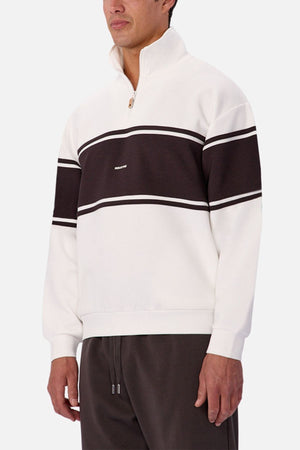 Someone styled the Industrie The Tech Southend Track Top—white with a black horizontal stripe, white trim, and small logo—with dark pants for a casual vibe. Its tech fabric ensures comfort and style.