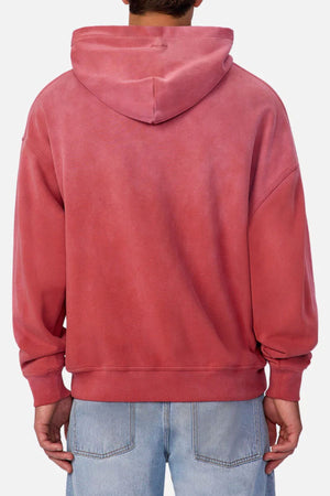A person is seen from the back in a faded pink Industrie The Sandblast Hoodie and light blue jeans against a plain background, showcasing a relaxed look in 100% cotton comfort.
