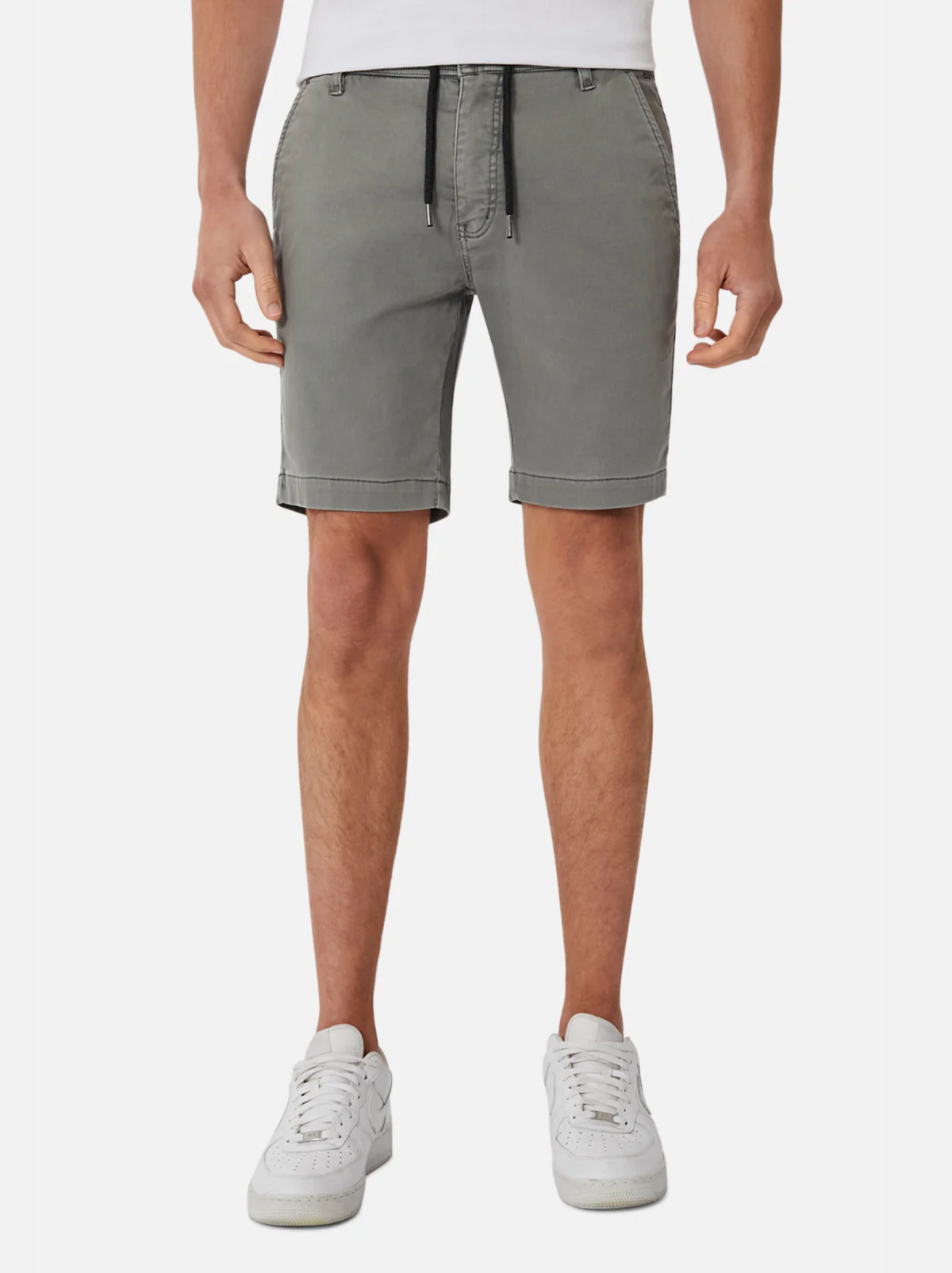 A person wearing Industrie The New Drifter Cuba Short—modern slim fit, grey knee-length smart casual shorts with a black drawstring—paired with a white shirt and white sneakers, stands against a plain white background.