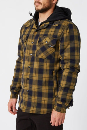 Man wearing a Jetpilot Quilted Flannel Jacket, featuring yellow and navy cotton flannel with a hood, paired with black pants and a black shirt, standing against a plain white background.