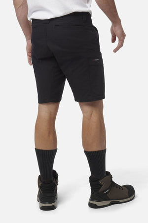 Someone stands facing away, wearing black King Gee Workcool Pro Shorts made from ripstop stretch fabric, paired with black socks and brown hiking boots, against a plain white background.