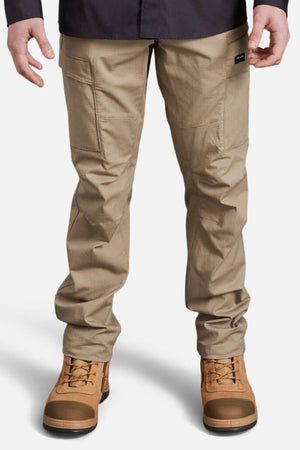 A person wearing King Gee Workcool Pro Stretch Cargo Pant, made from stretch ripstop fabric, and brown work boots stands against a plain white background, with only their lower body visible.