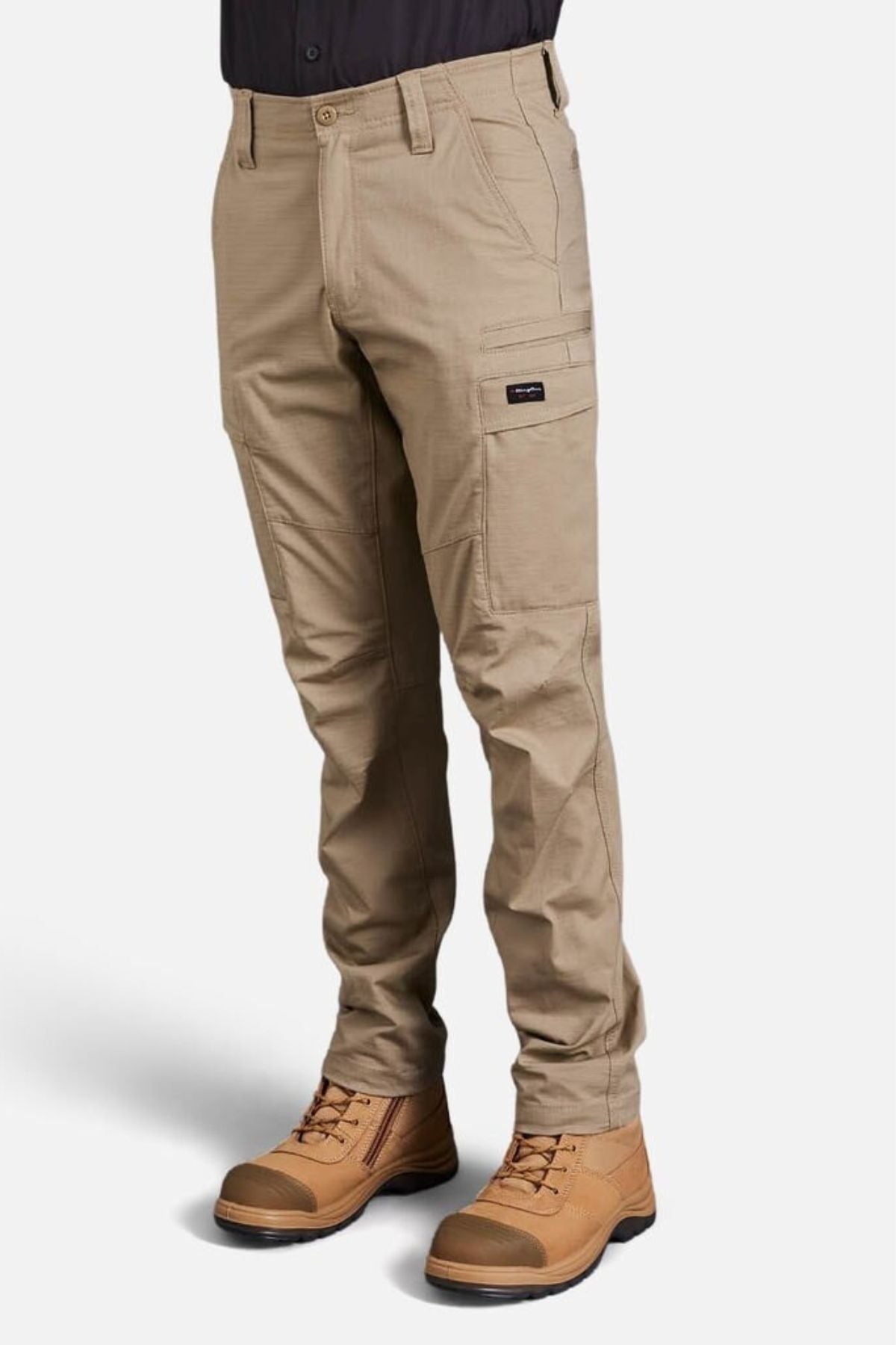 A person wearing King Gee Workcool Pro Stretch Cargo Pant with multiple pockets and brown work boots stands against a plain white background. Only the lower body is visible.