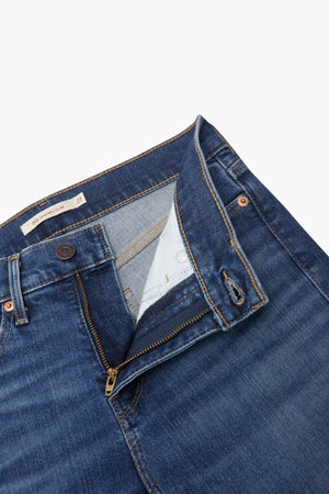 A close-up of Levis 312 Shaping Slim Jean with a partially unzipped fly and unbuttoned waistband, revealing the inside lining and pockets against a white background.
