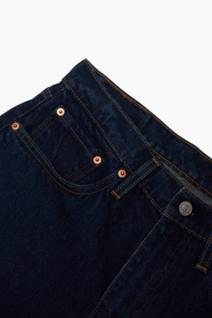 Close-up of Levis 516 Straight Jean in dark blue denim with front and coin pockets, orange stitching, and a metal button. This classic straight-leg jean offers Comfort Stretch for easy movement.