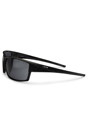 The Liive X Ignite X Sunglasses are black wraparound shades with dark lenses, thick arms, a modern silhouette, and the "Liive" brand name in white on the left arm.