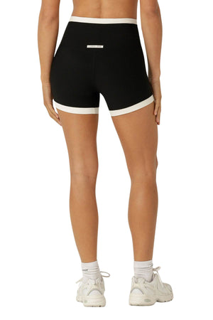 A person’s legs and Lorna Jane Gym to Swim Retro Rib 12cm Bike Short, made from moisture-wicking fabric.