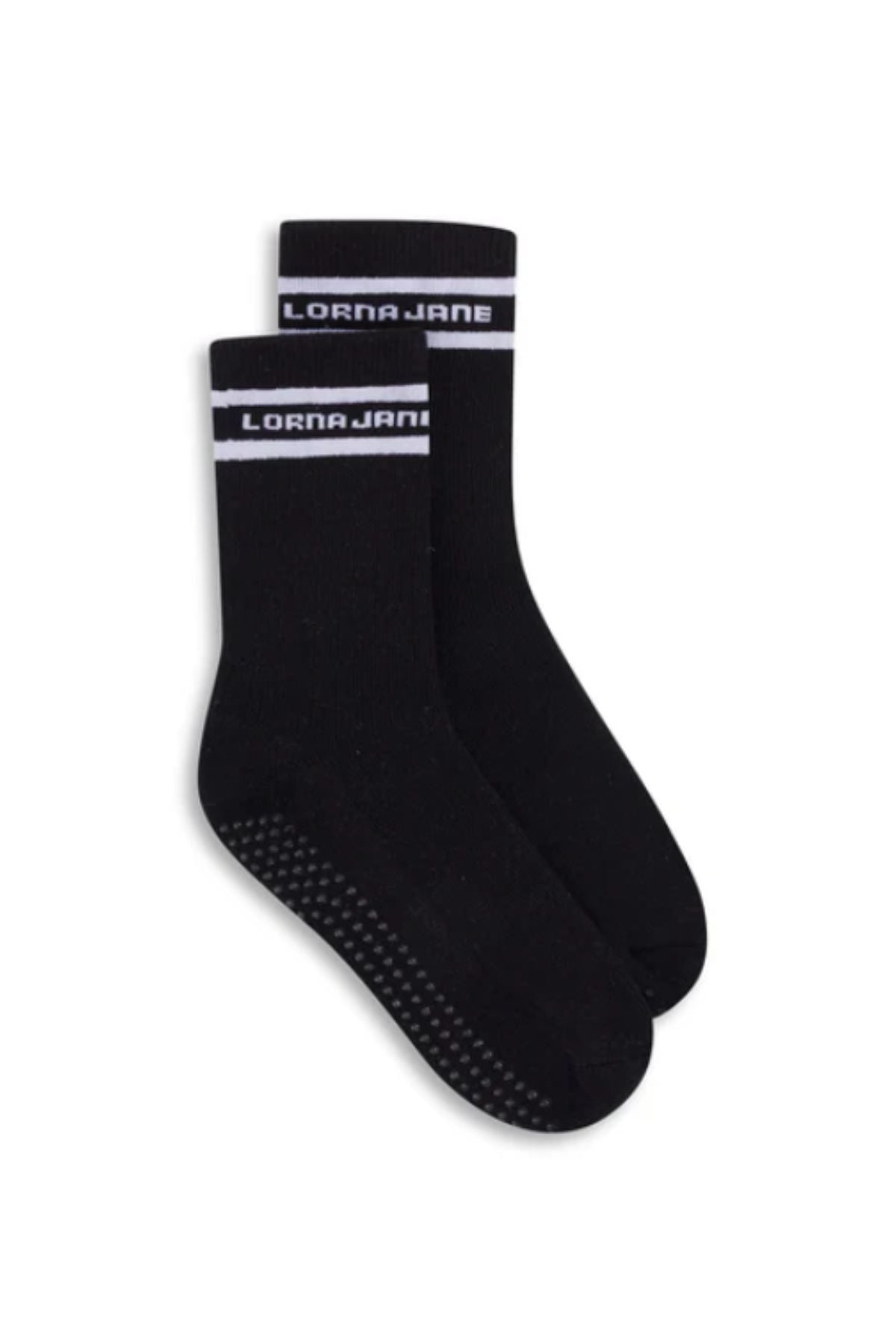 The Lorna Jane Pilates Grip Crew Socks are black crew socks with white stripes and "LORNA JANE" at the top, featuring rubber grip dots on the soles for enhanced traction and stability.
