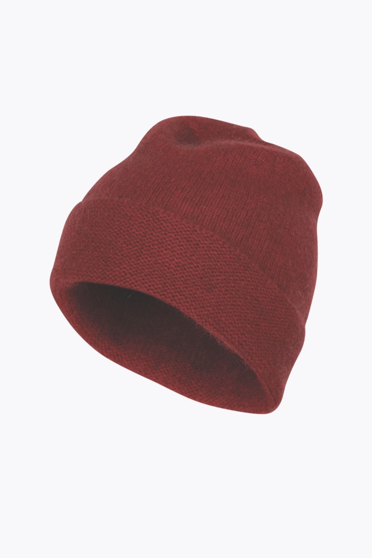 The MKM Plain Beanie Possum, in a rich red hue and made from premium merino wool, is showcased against a stark white backdrop. It boasts a straightforward folded brim and offers a subtly textured look.