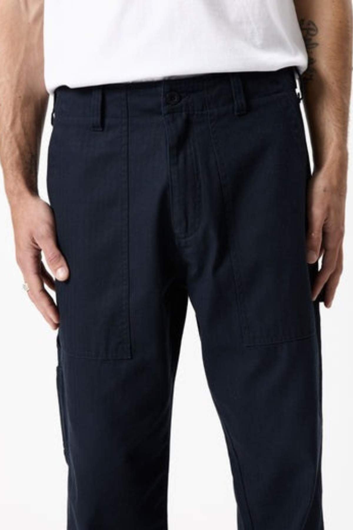 Someone wearing the Mr Simple Carpenter Pant in dark navy with a relaxed fit and a white t-shirt, shown from waist to mid-thigh, hands resting naturally at their sides.