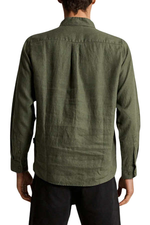 A person is seen from the back wearing a loose-fit olive green Mr Simple Linen Long Sleeve Shirt. The shirt has a simple design with a collar and cuffs, paired with dark pants that highlight its texture and fit.