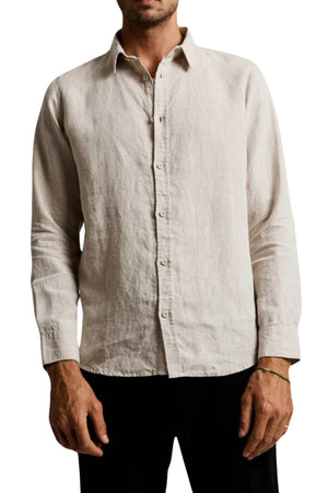 A person wearing the Mr Simple Linen Long Sleeve Shirt in beige paired with dark pants. The outfit is relatively casual with stylish details, and the photograph is cropped from the neck down to the upper thighs.
