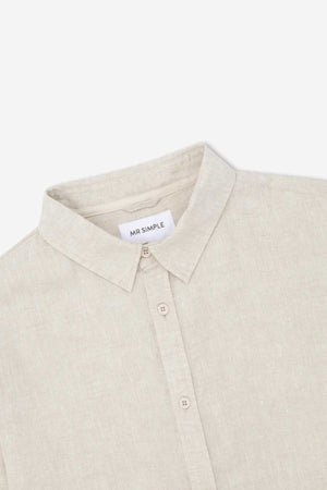 A detailed view of the Mr Simple Linen Long Sleeve Shirt in light beige, showcasing its 100% linen fabric and button-down collar. Stylish details such as a "MR SIMPLE" label sewn into the neckline are highlighted. The lightweight material looks soft and ideal for both casual and semi-formal occasions.