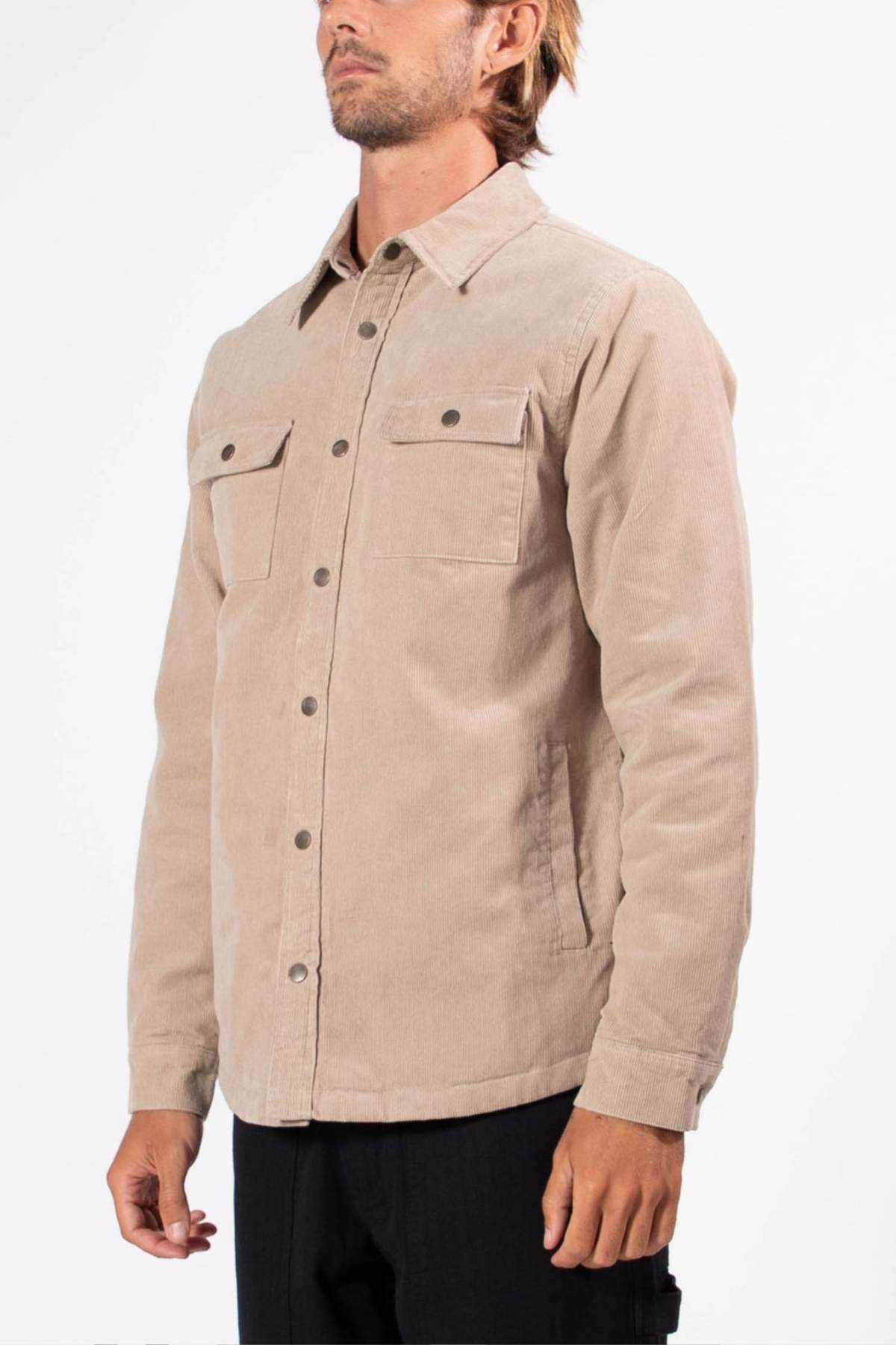 A man wearing the Mr Simple Quilted Cord Jacket in beige, featuring snap closure and two chest pockets, stands against a plain white background.
