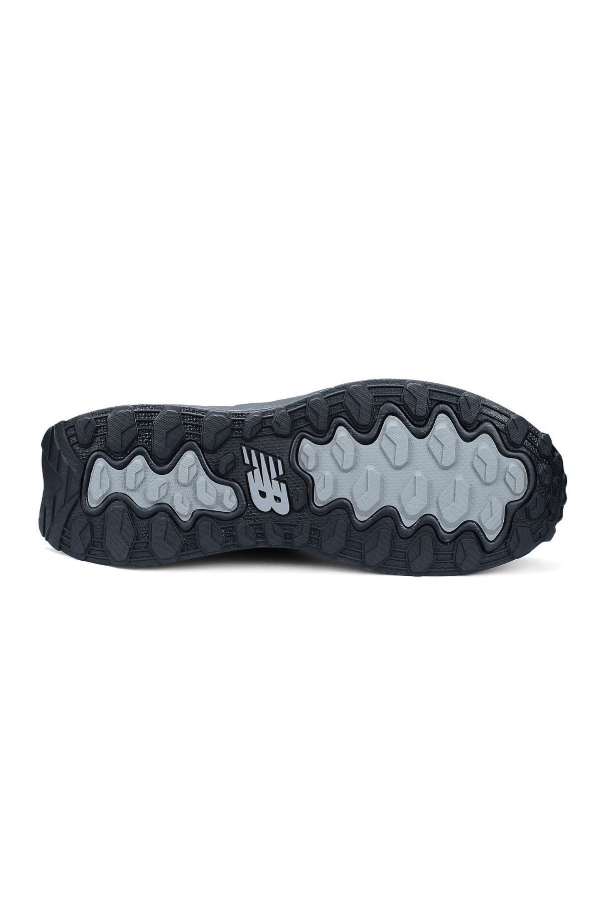 The image shows the black and gray rubber outsole of the New Balance Cremorne Safety Shoe, featuring a wavy, slip-resistant tread pattern and a white New Balance logo at the center.
