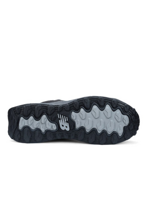 The image shows the sole of the New Balance Cremorne Mid Safety Shoe, featuring a grey and black rugged, slip-resistant pattern with the "NB" logo visible near the heel.