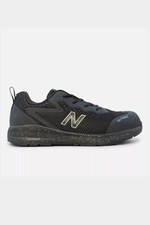 The New Balance Logic Safety Work Shoe is a black athletic safety shoe featuring slip-resistant properties, a reinforced toe, and a speckled rubber sole. The shoe boasts a prominent grey "N" logo on the side, along with a breathable mesh upper and a pull tab at the heel for enhanced comfort and support during physical activities.