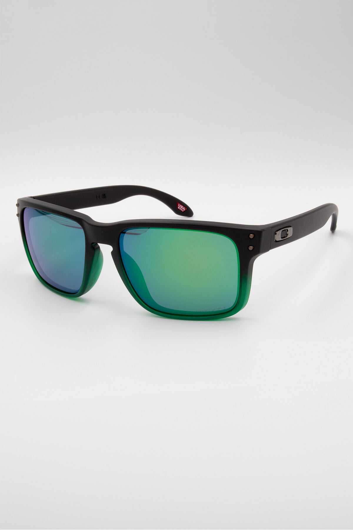 The Oakley Holbrook sunglasses, featuring lightweight O Matter frames and reflective green lenses, are displayed on a plain white background for enhanced optical performance.