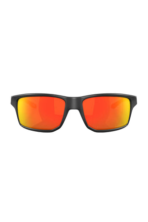 A pair of Oakley Gibston Polarized sunglasses featuring black rectangular frames and bright orange-red Prizm lenses, displayed against a white background.
