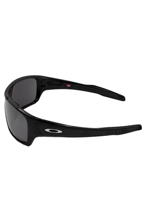 The Oakley Turbine Rotor sunglasses feature a sleek, sporty wraparound design with dark lenses, a white Oakley logo on the arm, and “Oakley” embossed on the temple.