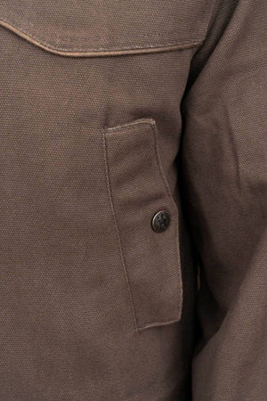 Close-up of the textured brown fabric of an Outback Cattleman Jacket, highlighting a buttoned pocket with visible stitching. The material looks thick and durable. Featuring a brass 2-way zipper, this jacket offers both style and functionality for outdoor use.