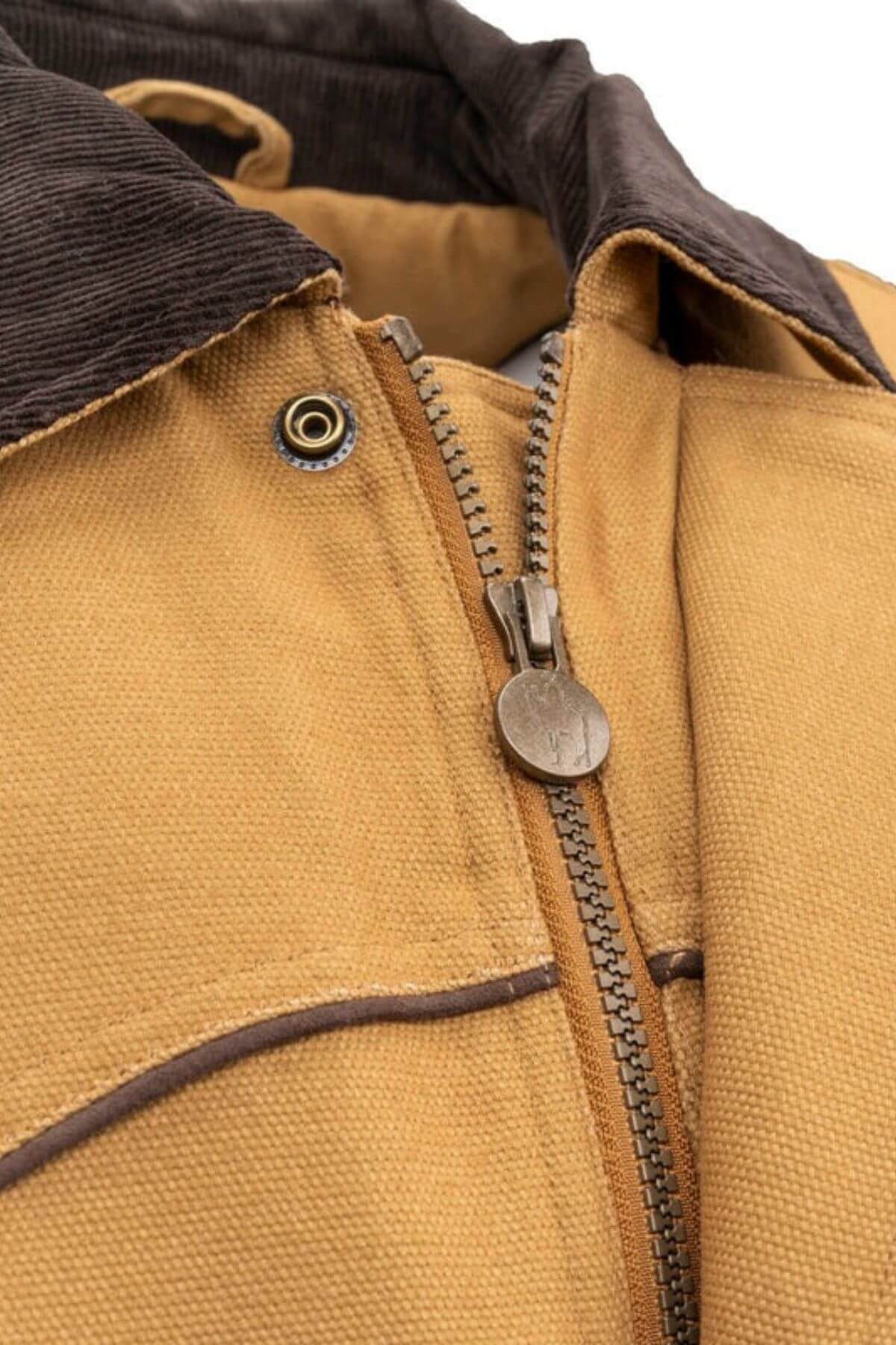 Close-up of the Outback Cattleman Jacket in tan, with a partially zipped metal zipper and a dark brown corduroy collar. This outdoor essential features metallic buttons, stitching details, and multiple pockets, emphasizing its texture and design.