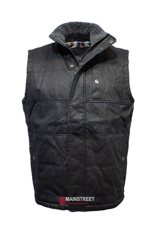The Outback Heritage Oilskin Vest is a black quilted piece with plaid lining, a sherpa-lined collar, and weather resistance. It includes snap button closures and pockets, with a "Mainstreet Clothing Destination" tag at the bottom.