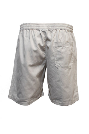 The Pilgrim Twill Rugger Short, made of soft cotton in beige, features an elastic waistband and a single back pocket, and is displayed from the rear against a white background.