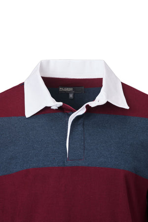 A close-up of the Pilgrim Rugby Top featuring a white collar, navy blue and burgundy stripes, button placket, and visible "PILGRIM" brand label with size "M" inside the collar—classic vintage sportswear style.