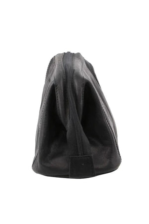 The Pierre Cardin Leather Toiletry Bag in black genuine leather stands upright in a side view, showing a top zipper. The travel toiletry bag appears empty and slightly collapsed.