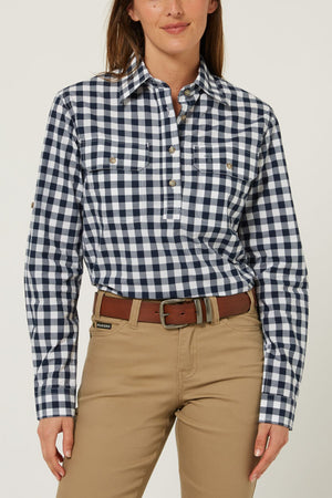 A person is wearing the Pilbara Ladies Check Closed Front Long Sleeve Shirt in navy and white checks with khaki pants, standing against a plain light background.