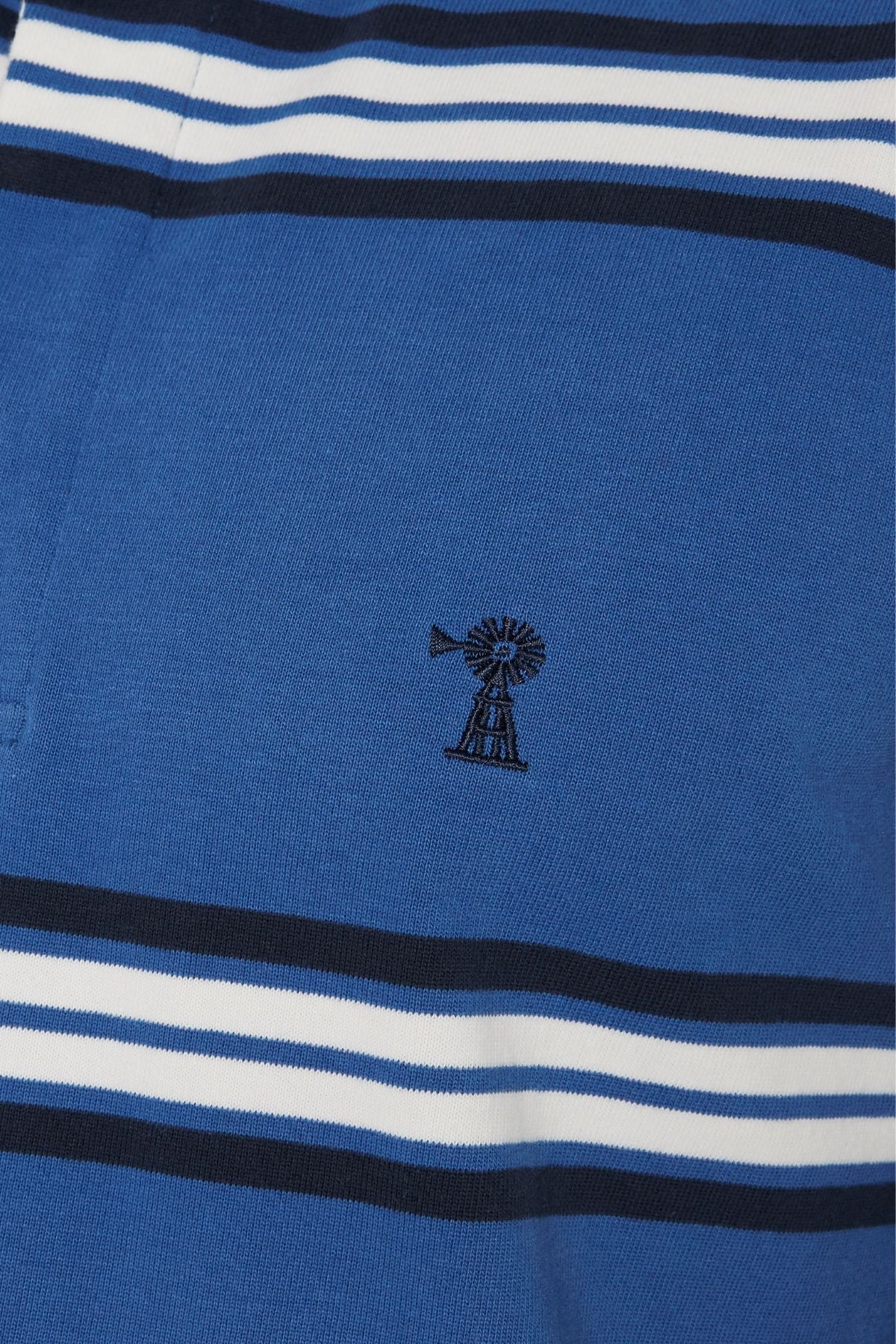 The Pilbara Rugby Jersey features blue fabric with horizontal white and navy stripes plus a central small black windmill embroidery, echoing the style of a classic rugby jersey.