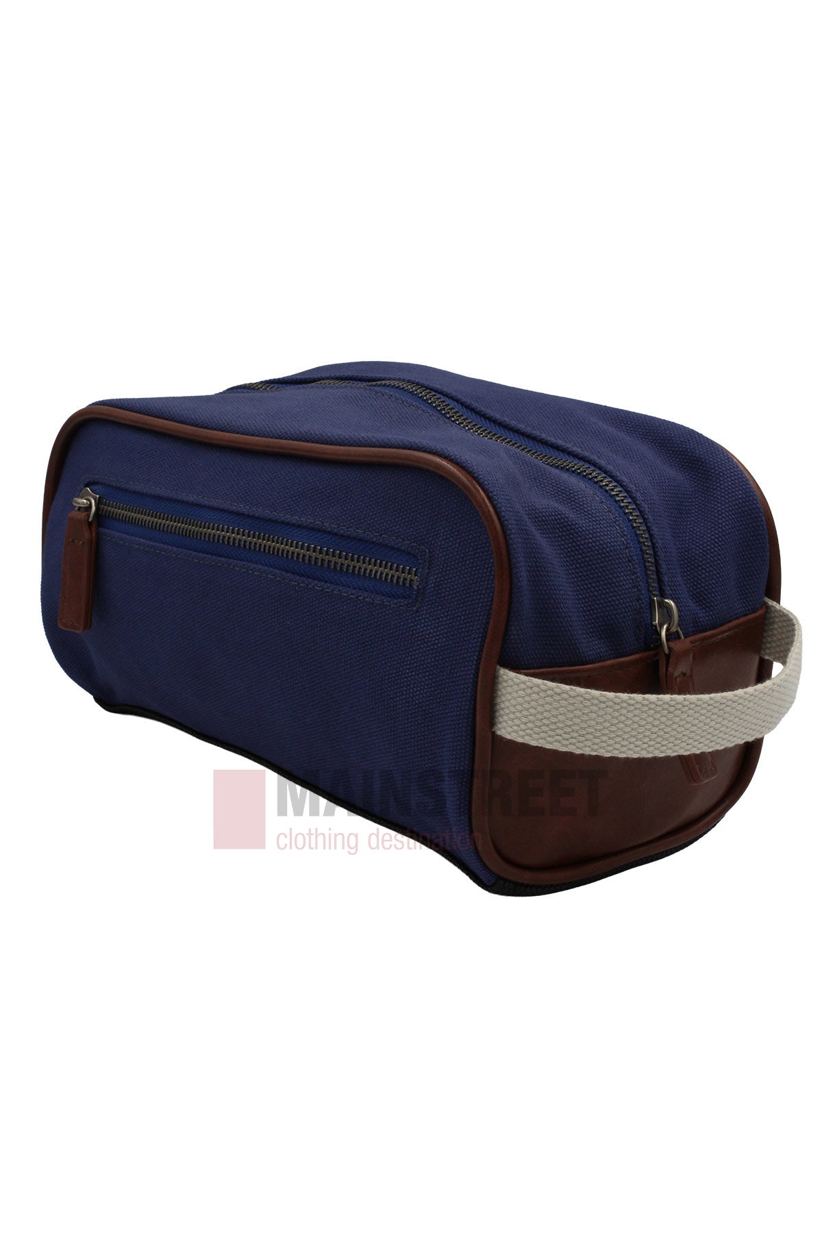 The Pilbara Toiletry Bag, crafted from premium navy canvas with brown leather trim, features a front zip pocket and a beige woven handle at one end. It is displayed resting on a white surface.