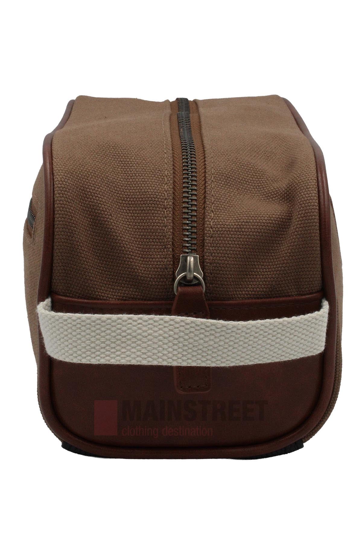 The Pilbara Toiletry Bag features premium canvas, a top zipper, brown leather trim, and a white fabric handle, displayed from the front against a plain background.