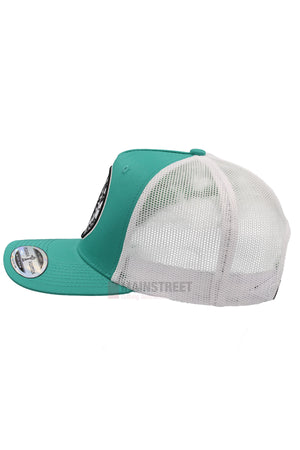 A side view of the Pilbara Western Established Cap shows its teal front with a circular patch, white mesh back for breathability, and round sticker on the brim—ideal for outdoor adventures.