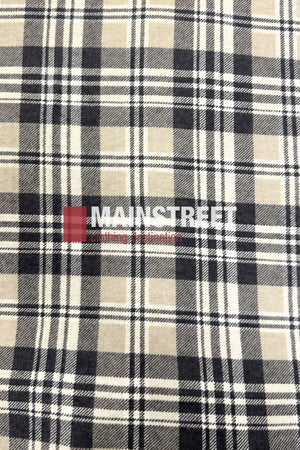 A close-up of the Pilgrim Closed Front Flannelette Shirt - King Size shows its beige, black, and white plaid fabric with "MAIN STREET Clothing & Uniforms" printed in white and red across the center.