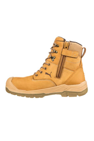 A tan Puma Conquest Waterproof Safety Boot with a beige rubber sole, featuring laces and a side zipper. The small puma logo is near the midfoot, and there's a pull tab at the back. It has a fiberglass toe cap and appears sturdy for heavy-duty use.