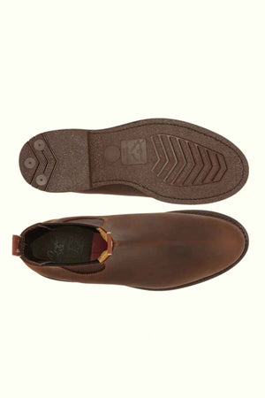 The RM Williams Gardener Boot is a pair of brown water-resistant leather Chelsea boots, with one shown from the top and the other displaying its textured sole and heel; available in unisex sizing.