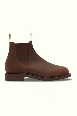 The RM Williams Gardener Boot is a brown water-resistant leather Chelsea boot with elastic side panels, front and back pull tabs, a low heel, and rounded toe. Unisex sizing offers a perfect fit for all. Displayed on a light background.