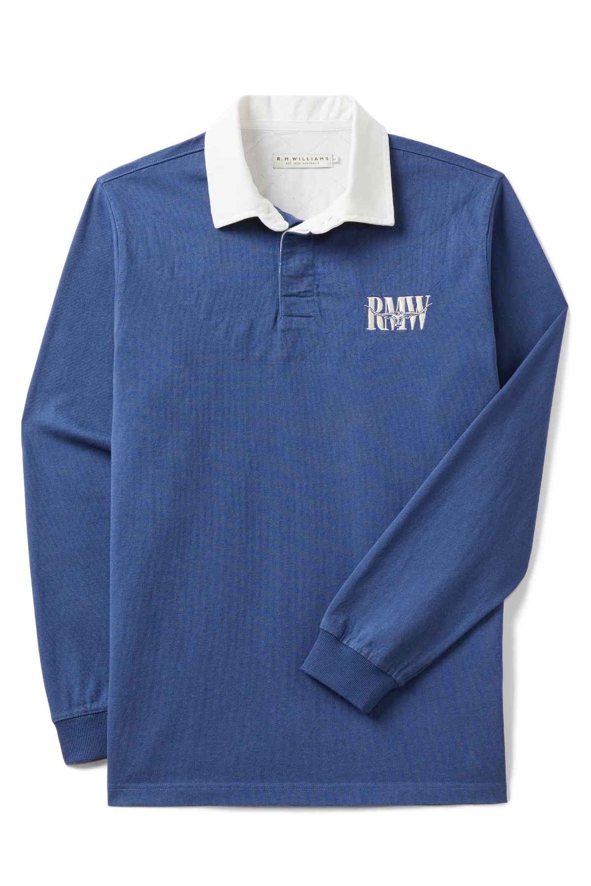 The RM Williams Steers Head Rugby is a long-sleeve blue jersey with a white collar, "R.M.W." on the left chest, and crafted from organic cotton. It features a buttoned placket and cuffs for classic style.