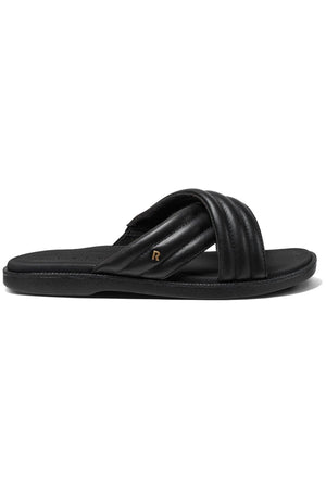 The REEF Lofty Lux X slide sandal in black features two padded crisscross straps, a small gold "R" emblem on the side, and is designed for premium comfort. Shown in a side profile against a white background.