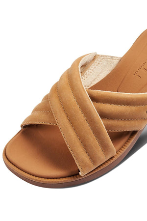Close-up of the REEF Lofty Lux X tan sandal with crisscross suede straps and a brown sole. The cushioned footbed provides comfort, while detailed stitching on this sustainable footwear adds stylish appeal.