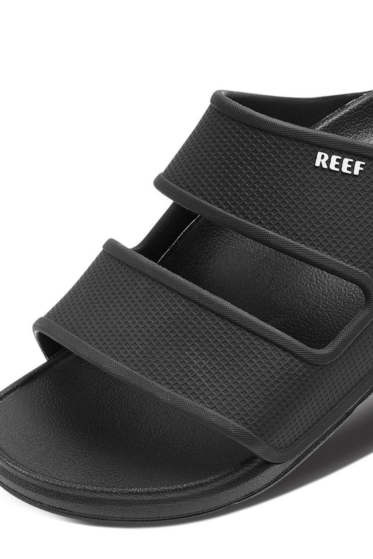 Close-up of the REEF Oasis Double Up sandal with three adjustable straps, "REEF" in white on the top strap, water-friendly materials, a textured finish, open-toe design, and excellent arch support for all-day comfort.