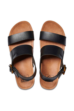A pair of REEF Vista Hi Buckle sandals in brown, featuring black vegan leather straps and ankle buckles, displayed from above on a white background.
